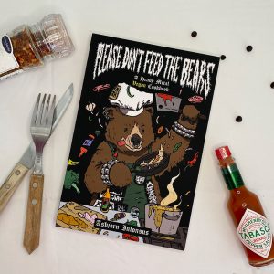 Kokebok illustrert med krydder, saus og bestikk
